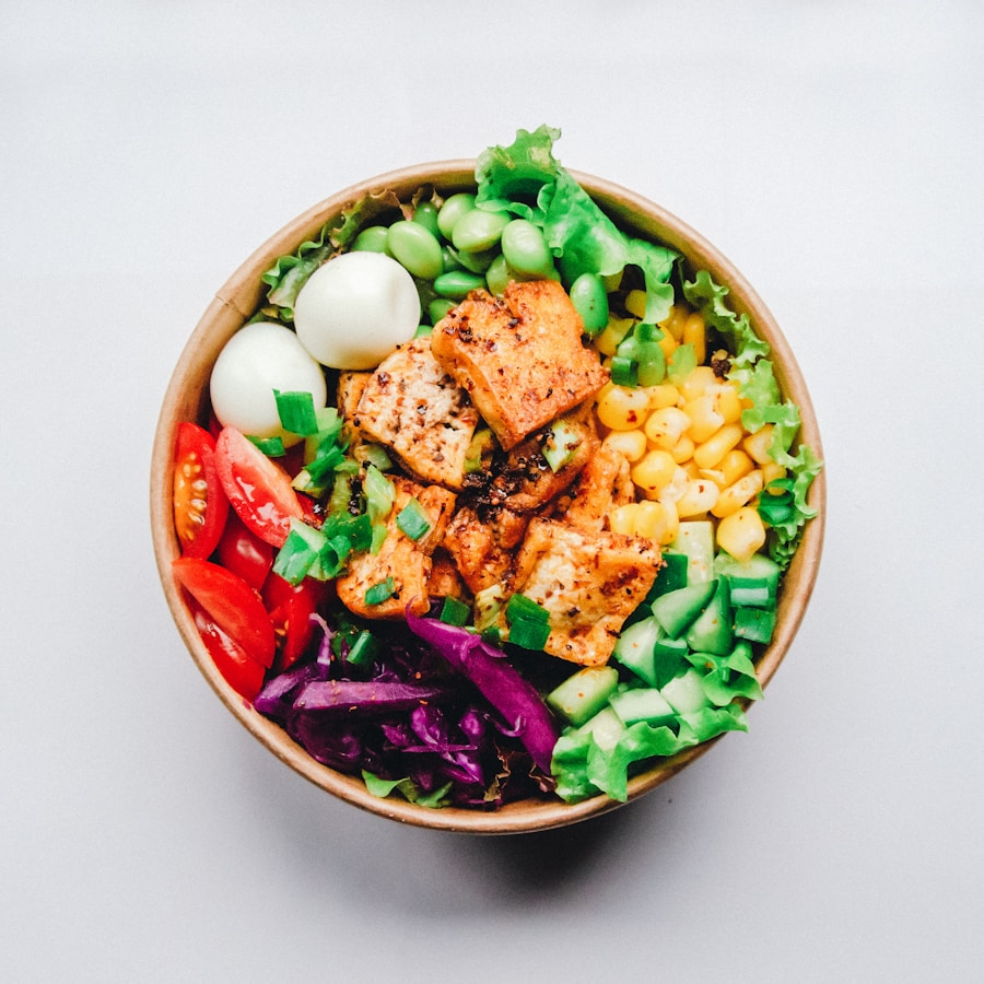 Plate with chicken, rice, vegetables, avocado, and salad